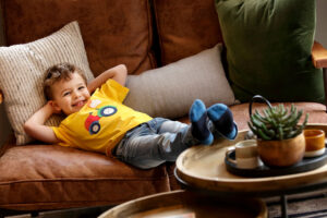 Small child relaxing inside a new house which Dupree and Co helped with their mortgage