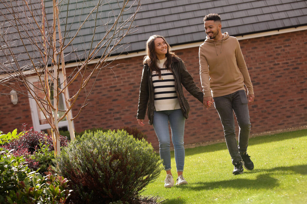 Young couple relaxing in the garden of their new house