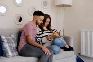 Young couple relaxing in the sitting room of their new house